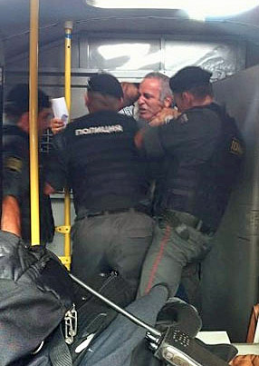 Kasparov being roughed up by Russian Police.