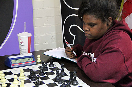 Jasmine Thomas playing at the St. Louis Chess Club in November.