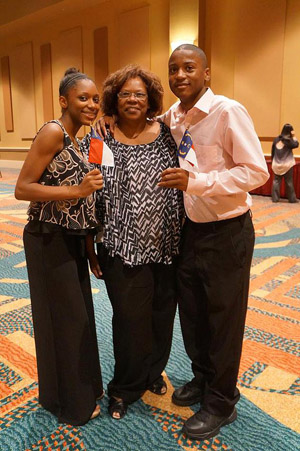 Emmanuel Carter with older sister Kydriana Carter and grandmother. Both players have represented North Carolina in a number of scholastic events. Their brother Lorenzo Carter (not pictured) also plays. Photo by Frank Johnson.