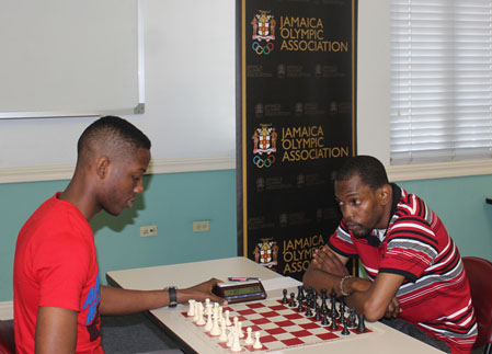 Nathan Hinds (L) about to face NM Daren Wisdom ® in their crucial final round clash in the 2015 Digicel President’s Invitational Chess Tournament at the Jamaica Olympic Association.