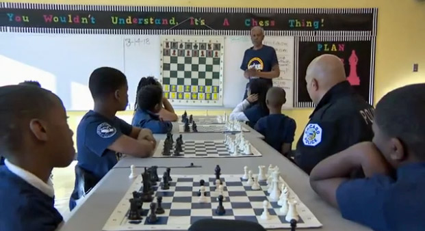 Sam Ford teaching chess at Alex Haley Academy. Photo taken from WTTW