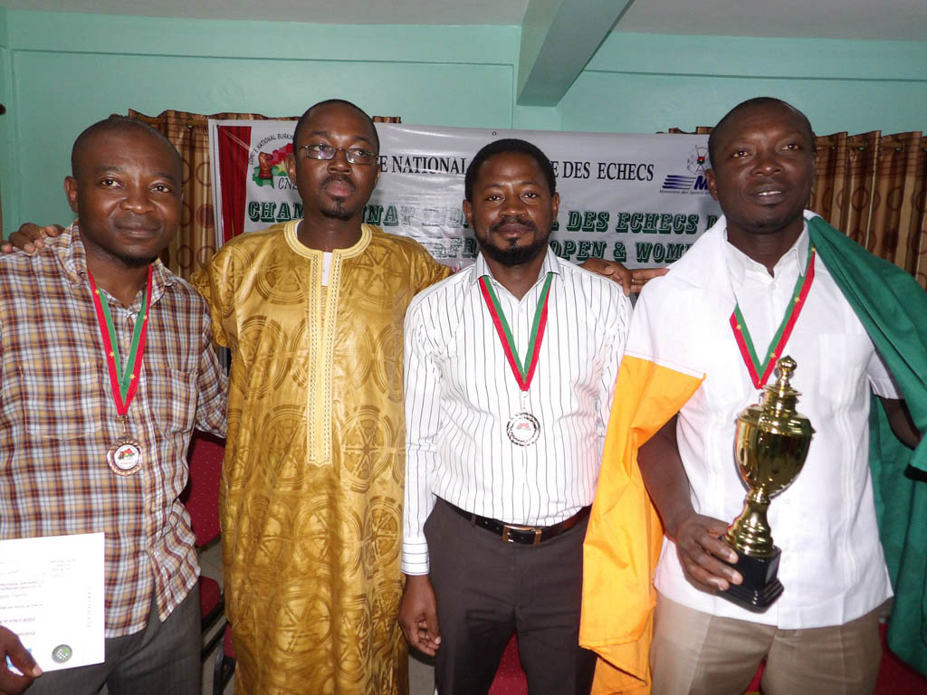 The Burkina Faso Chairman of the National Committee for Chess, Jean De Dieu Ouedraogo, (2nd from left) with winners at 4.4 Subzonal (from left to right), Geoffrey Adzua (Nigeria) – BRONZE medal, Yinka Adesina (Nigeria) – SILVER medal and Hermann Manan (Ivory Coast) – GOLD medal