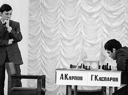 Anatoly Karpov hovers as Garry Kasparov ponders next move in 1984 match.