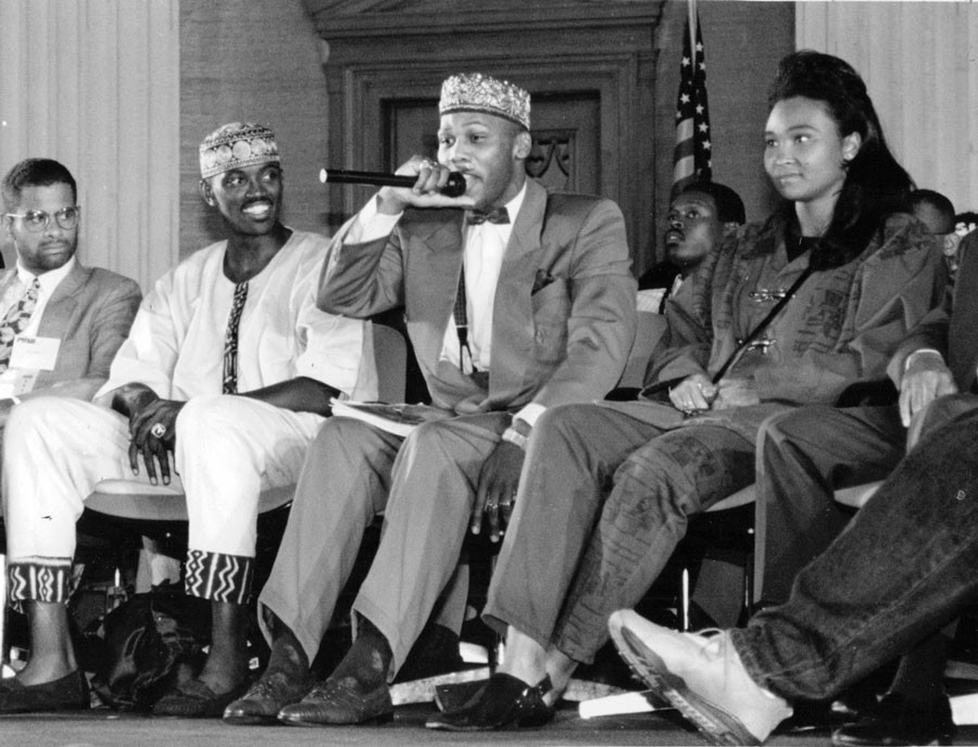 In September 1992, Craig Hodges (seated second from left) with rapper Prince Akeem (with microphone) and May May on Youth Empowerment Day at Operation PUSH headquarters. Photo by Sun-Times