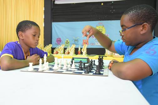 Young Jaheim Smart (right) from Lannaman’s Preparatory won the speed chess playoffs to become Under 12 Champion. He played Corbin Harvey (left) from Harrison’s Prep.