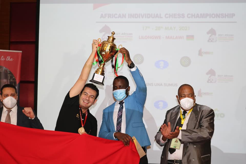 A victorious Ahmed Adly presented the championship trophy by Minister of Youth and Sport Ulemu Msungama with Egyptian Ambassador Maher Ely-Adawy (left) and President of African Chess Confederation Lewis Ncube (right).