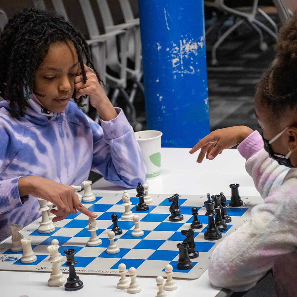 Girls playing chess as part of 'Black Squares' initiative