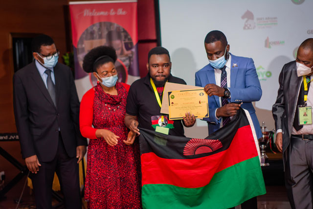 A moment of pride for Malawians as Mwale received his well-deserved commendation. Namangale looks on.