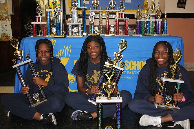 Shakira Luster, Trechelle Williams, and Imani Hill hoisting their trophies at the 2019 All-Grade Championships. Photo courtesy of Wendell Hutson