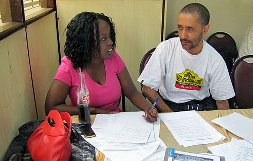 Our photographer Kim Bhari (right) here dissecting the action with Chess Kenya committee member Mary Kanyua.