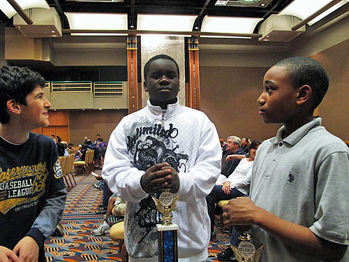 Issac Bareyev (left) and James Black, Jr. (right) enjoy the moment with I.S. 318 teammate, Justus Williams, 2010 National Elementary Champion