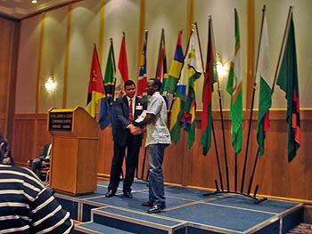 Uganda’s Steven Kawuma receiving his participation certificate.