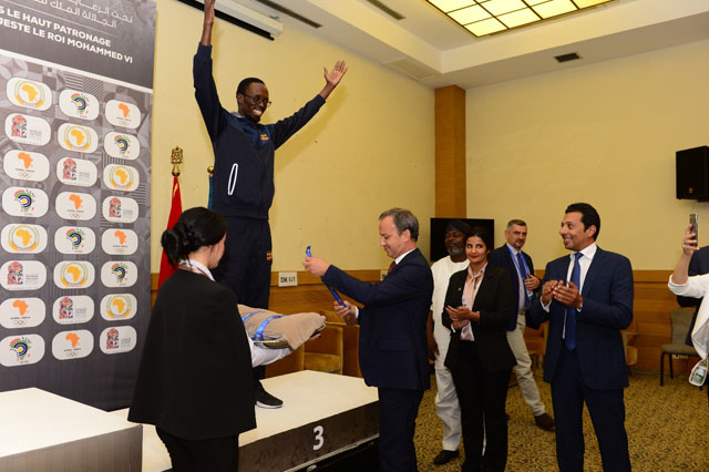 Harold Wanyama about to receive his bronze medal from FIDE President Arkady Dvorkovich. FIDE Vice President Mohamed Al-Modiakhi looks on. Photo by Mohamed Bounaji/FIDE