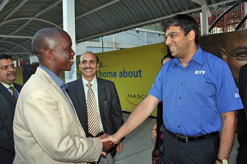 The President of Botswana Chess Federation Tshepo Sitale shakes hands with the champion.