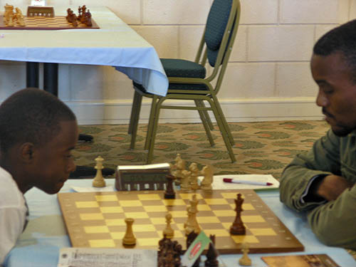 Josh defeating FM Ryan Harper at the 2010 Caribbean Chess Carnival in Trinidad. Photo by Daaim Shabazz.