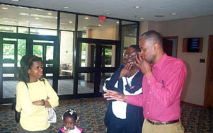 (L-R) Sue Barclay, Kara Barclay (4 yrs. old), Lester Barclay speak with Sam Ford about the Directors decision on Kayins game. Kayin won the game. Copyright © 2003, Daaim Shabazz