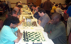 Open Section: FM Sunil Weeramantry vs. IM Oladapo Adu (foreground). Copyright © 2003, Daaim Shabazz