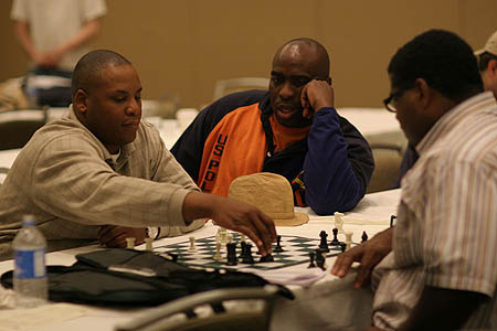 Marvin Dandridge watching Sedrick Prude and Vincent Bazemore analyze.