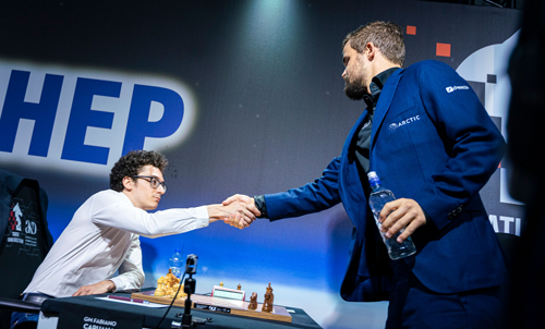 Fabiano Caruana greets Magnus Carlsen before round three