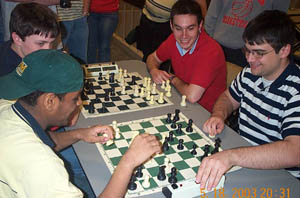 Bughouse Madness! Gulamali, the worlds strongest bughouse player gets mated by his oft-times partner, Richard Francisco. Copyright © 2003, Daaim Shabazz