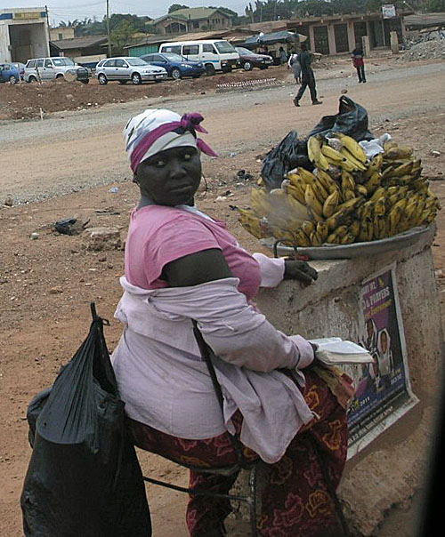 Vendor selling bananas. I was intrigued by these women who not only balance heavy load on their heads, but they were adept and dismantling their wares and serving quickly.