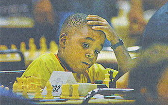 Ronnie wishes to become a Grandmaster and got his first taste of the U.S. media making the May 22nd Minneapolis Star-Tribune (Metro/State section). The Port-of-Spain resident scored 2-1 in the Scholastic Tournament during the HB Global Chess Challenge.