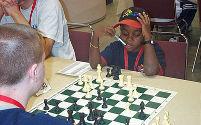 6-year old Ronnie Nelson ponders move at HB Global Chess Challenge