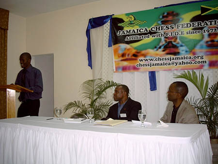 Amon Simutowe presenting an interesting lecture in Kingston, Jamaica about his chess beginnings and experiences. Ian Wilkinson (center) was the moderator and Daaim Shabazz had spoken earlier about The Chess Drum and chess psychology. Copyright  2004, Mark Bowen.