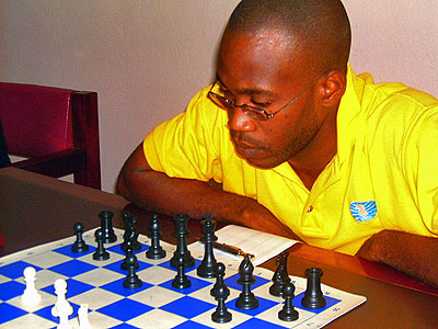 Equitable Brown has closed the gap to a mere -point. Warren Elliott, the leader, was upset by Mikhail Solomon. Photo by Jamaica Chess Federation.