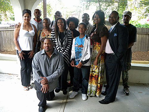 Players (rear) pose with the family of Liscious Williams. Photo courtesy of Frank Johnson (64 Squares).