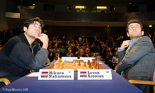 Both Nakamura and Aronian glances up at the display boards. Photo by Ray Morris-Hill.