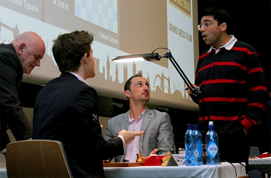 Carlsen explains to Anand why he took the pawn with 84. Nxe5. Photo by Amruta Mokal.