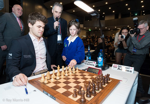 Girl plays 1.Nc3 for ceremonial move. Would Carlsen keep that move? Photo by Ray Morris-Hill.