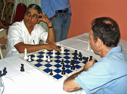 Jamaican National Master Shane Matthews (left) analyses his Round one game with Cuban International Master Jose Vilela.