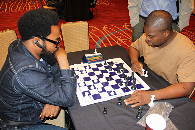 IM Daniel Jere (right) blitzing between rounds. Photo by Daaim Shabazz.