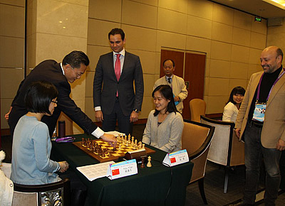 Hou Yifan (China) and Zhao Xue (China) set to face off after ceremonial moves.