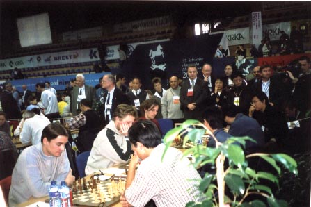 The Bears vs. The Dragons. Ye Jiangchan (far right) waits for GM Garry Kasparov, who arrived five minutes into the round. He then led Russia to a 3-1 victory over the Chinese. Copyright  Ian Wilkinson, 2002.