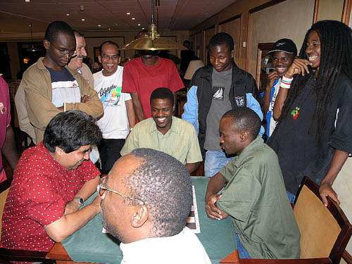 During Peru vs. Uganda, trash-talking was rampant. John Kikonyongo of Uganda (with the glasses) was hilarious! There were players many countries either playing blitz on surfing on the computers. Photo by Daaim Shabazz.