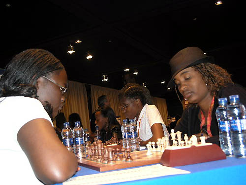 Kenya vs. Botswana - Tshepiso Lopang (near right) faces Linda Abur Amolo on board #3 while Tuduetso Sabure (center) and Boikhutso Mudongo (far end) ponder their next moves.