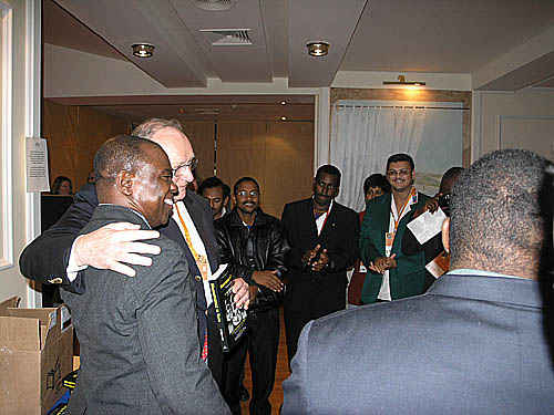 Wilkinson presents book to Chief Arbiter at the Bled Olympiad, Geurt Gjissen. South African Chess President Lyndon Bouah is in the green jacket. He received a donated copy from Jerry Bibuld. For permission to use the photographs in the book, Bibuld asked that Wilkinson present copies to three federations: South Africa, Kenya and Mozambique.