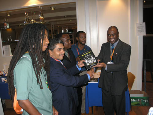 Wilkinson presents a copy to the Jamaican National Team. (L-R) Malaku Lorne, Shane Matthews, Duane Rowe, Russel Porter