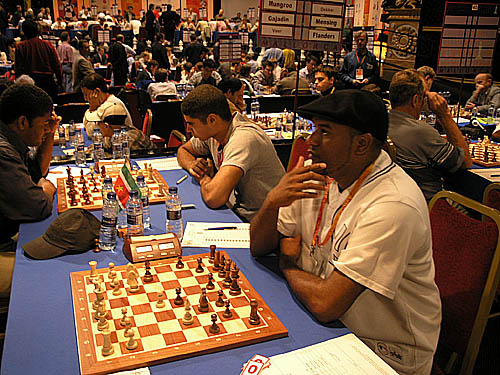 Netherlands Antilles Sherman Maduro (right) awaits opponent while his teammate Marvin Dekker faces off against Franklin Munagroo of Suriname.