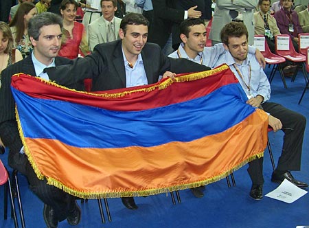 Armenian Men hoist national colors after winning gold medal at 37th Chess Olympiad. Seated are: Vladimir Akopian, Karen Asrian, Gabriel Sargissian, Levon Aronian. Photo by ChessBase.