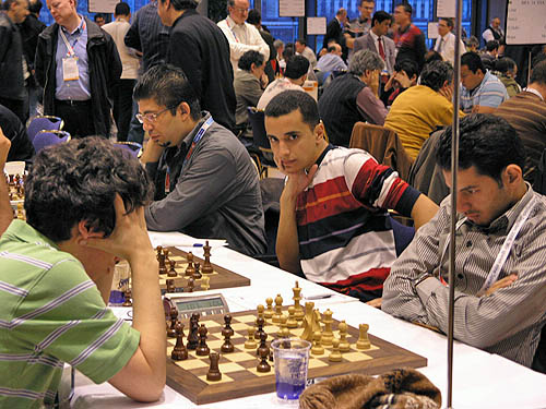 Costa Rica vs. Egypt (men).
Egyptian GM Bassem Amin catches a glimpse of camera. Also pictured are GM Ahmed Adly (right) playing GM Alejandro Ramirez and IM Ali Frhat. Photos by Daaim Shabazz.