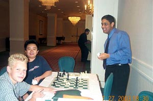 Young Stars: (L-R) Aleksander Dementiev, Xiao Cheng and Kazim Gulamali eating a piece of cake! Copyright © 2003, Daaim Shabazz