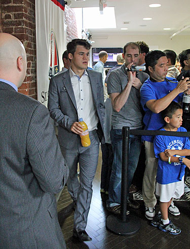 Carlsen arrives with Evian orange juice!