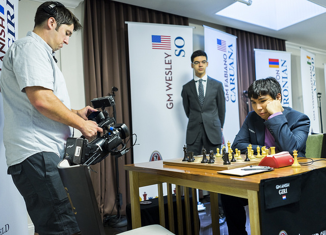 Wesley So on the move as Anish Giri kibitzes.