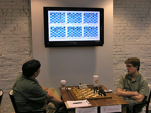 GM Larry Christiansen checks out the games while Tyler Hughes is on the move. Photo by Daaim Shabazz.