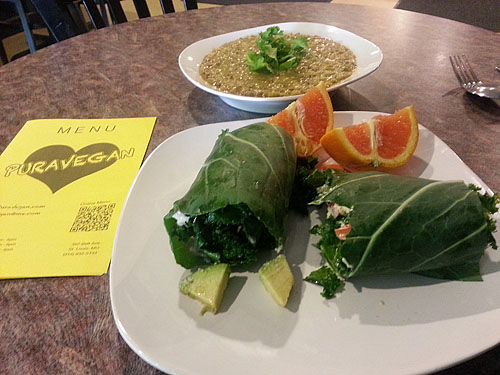 What are these strange-looking foods? At the top is a mung bean/quinoa stew (spicy) and at the bottom we have a chopped kale medley with avocado wrapped in collard leaf like a burrito... very tasty!! Surprisingly an orange drizzle brought out the flavor nicely. I had already taken a bite. :-P