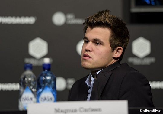 A dejected Carlsen ponders moments before storming out of the press conference. Photo by Albert Silver.